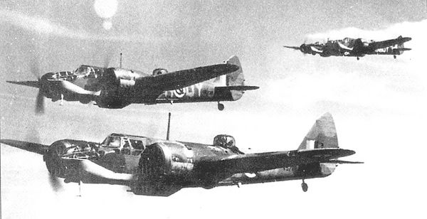 Black and white photograph of three Royal Air Force Bristol Blenheim fighter bombers in flight formation against a clear sky, with visible roundels and squadron codes on the fuselage
